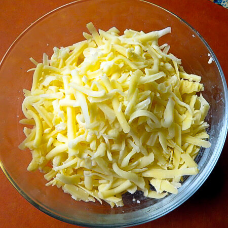 two types of shredded cheese in a bowl